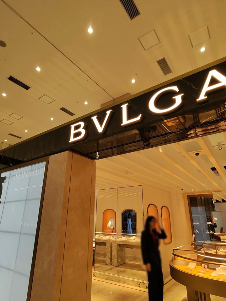 BVLGARIの店舗エントランス、照明が輝くロゴとガラスケースにジュエリーが飾られている